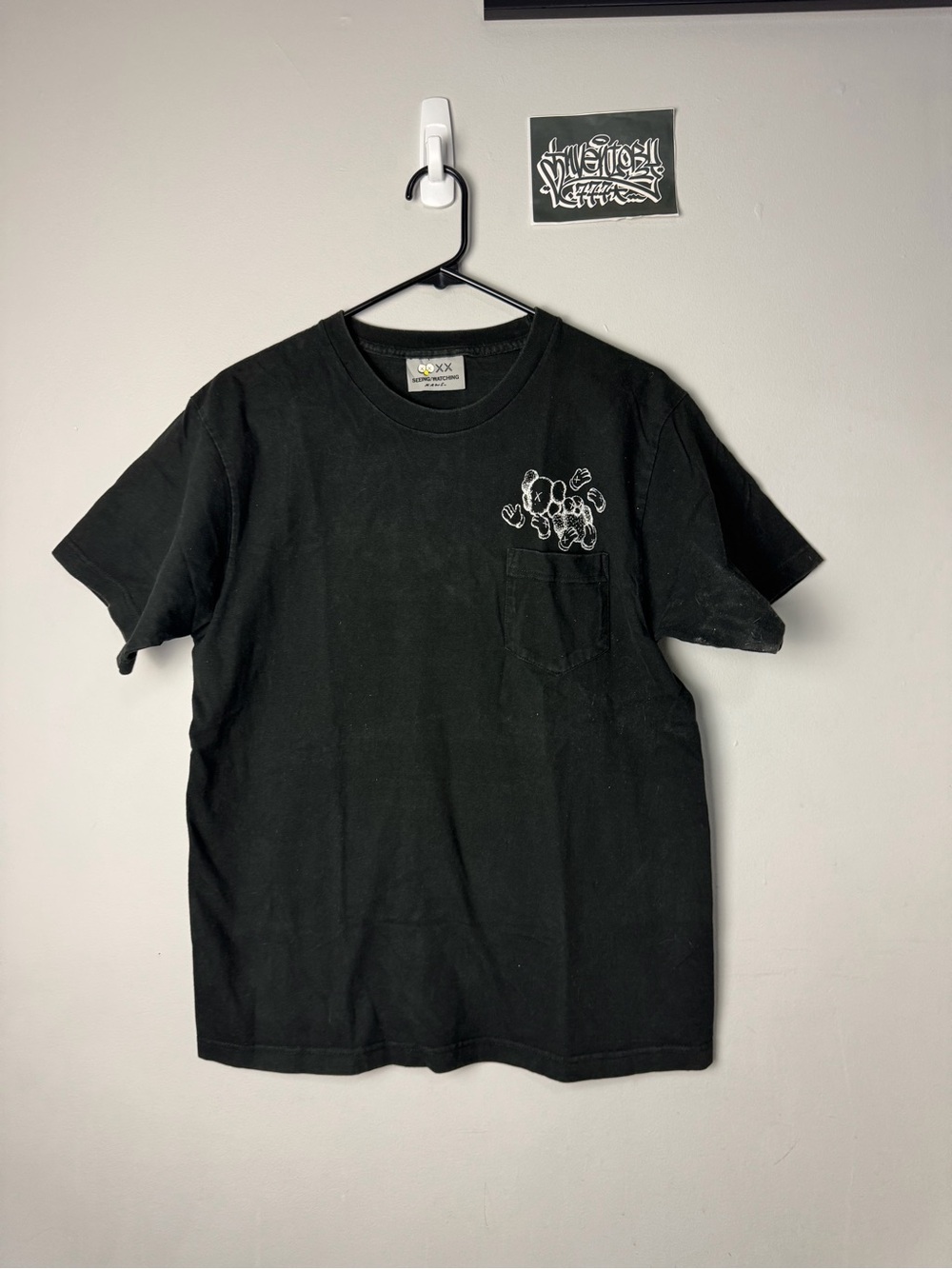 KAWS Black Short Sleeve Pocket Tee with White Chest Graphic